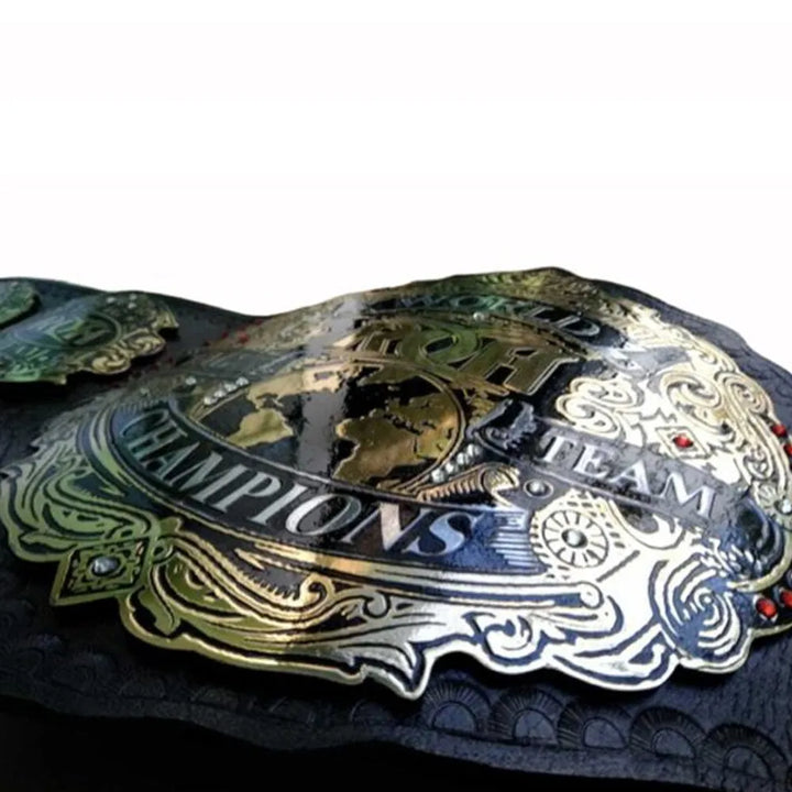 Close-up of ROH replica championship belt with intricate gold detailing and team champions emblem