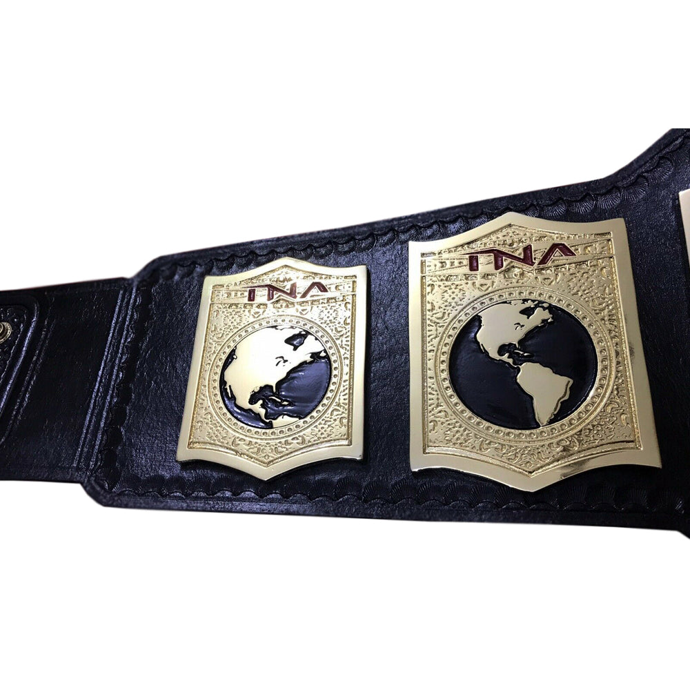 Close-up of TNA tag team championship belt with detailed gold plates and black leather strap